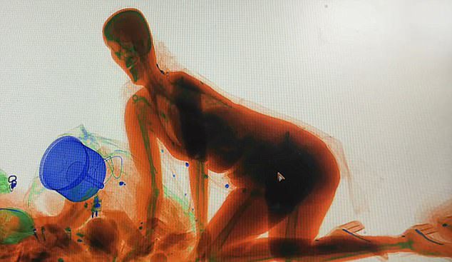 woman climbs X-ray machine